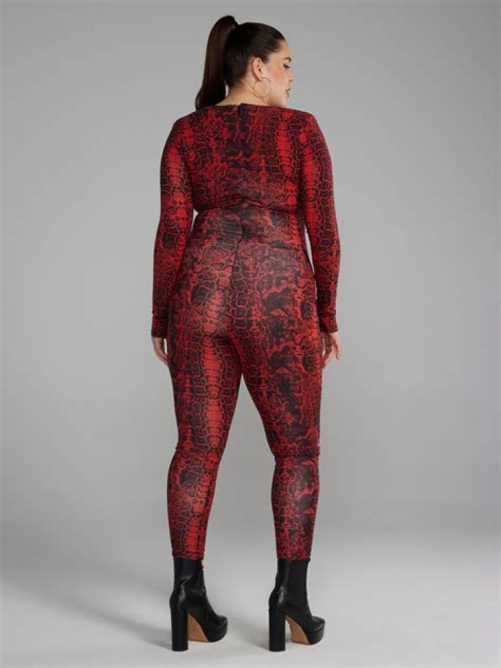 Kim Kardashian sticks out famous butt in tight snakeskin catsuit for new video as she plays mini gol